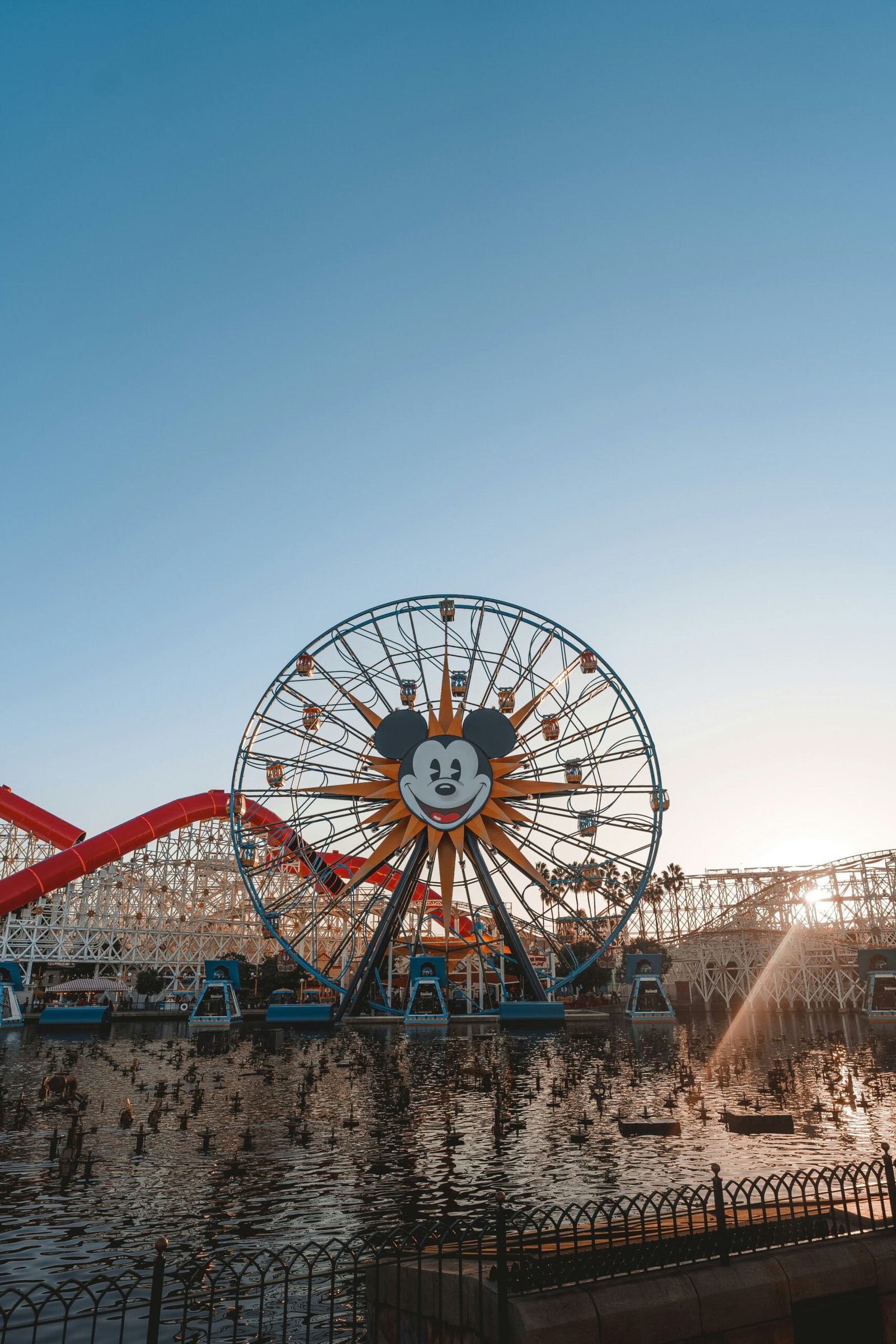 a large ferris wheel sitting next to a body of water